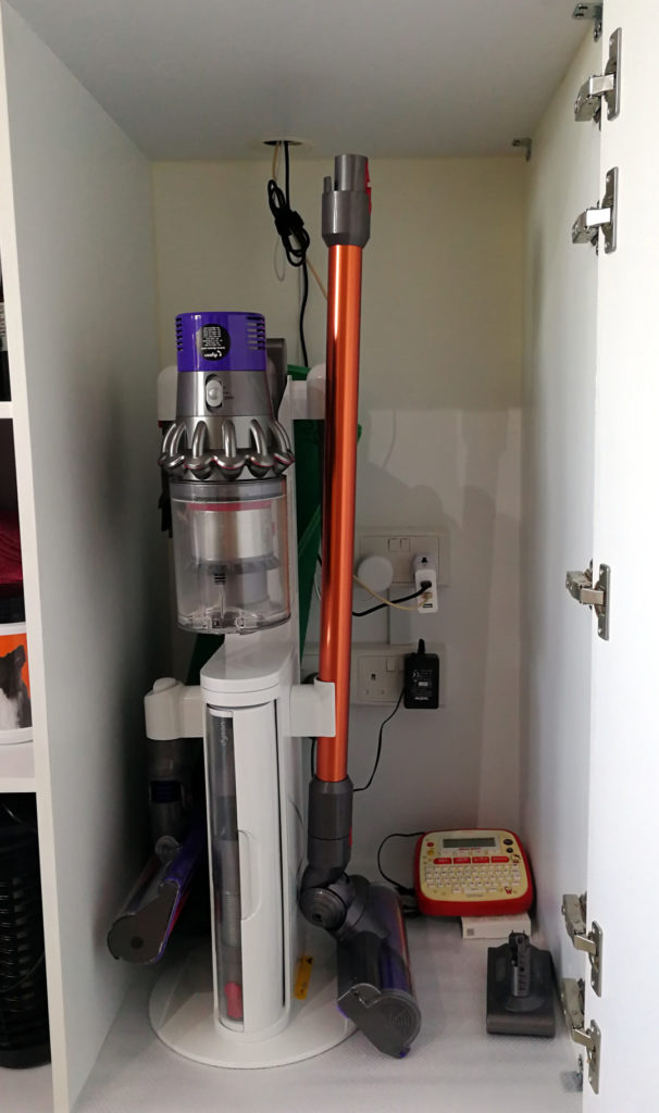 The Dyson V10 Dok well tucked away in my cabinet / charging station.