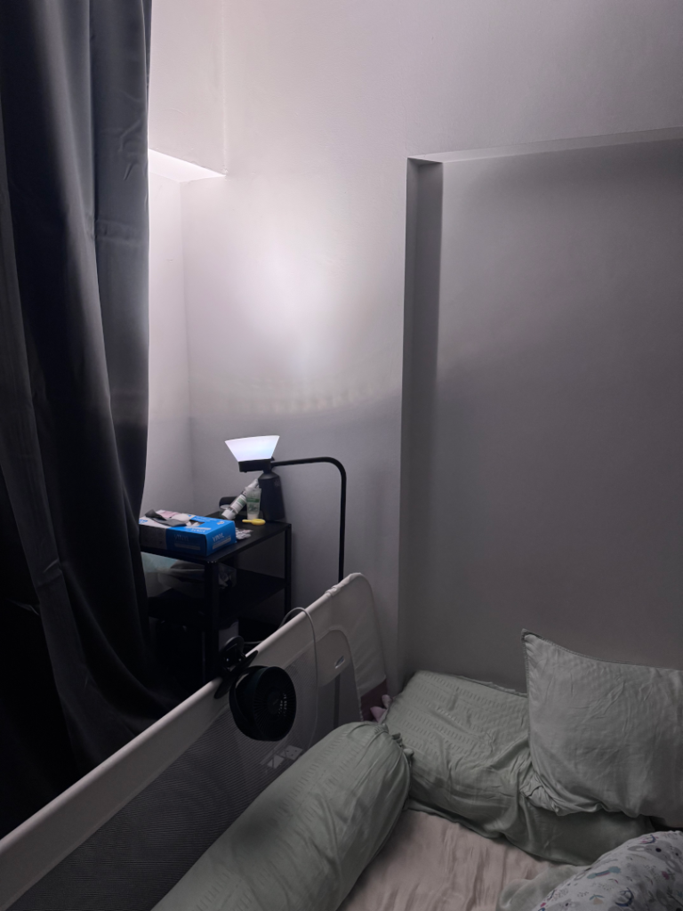 IKEA Sambord floor lamp with a dim Solhetta bulb bouncing soft light off the bedroom wall at bedtime