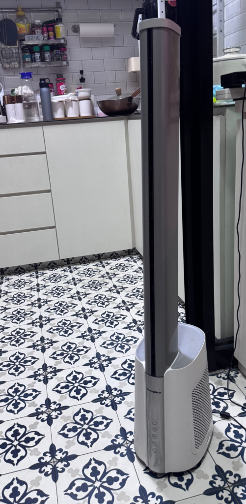 A tall silver-and-white Europace EBFZ2WH bladeless tower fan with a HEPA filter in its base, standing on patterned floor tiles in a kitchen.