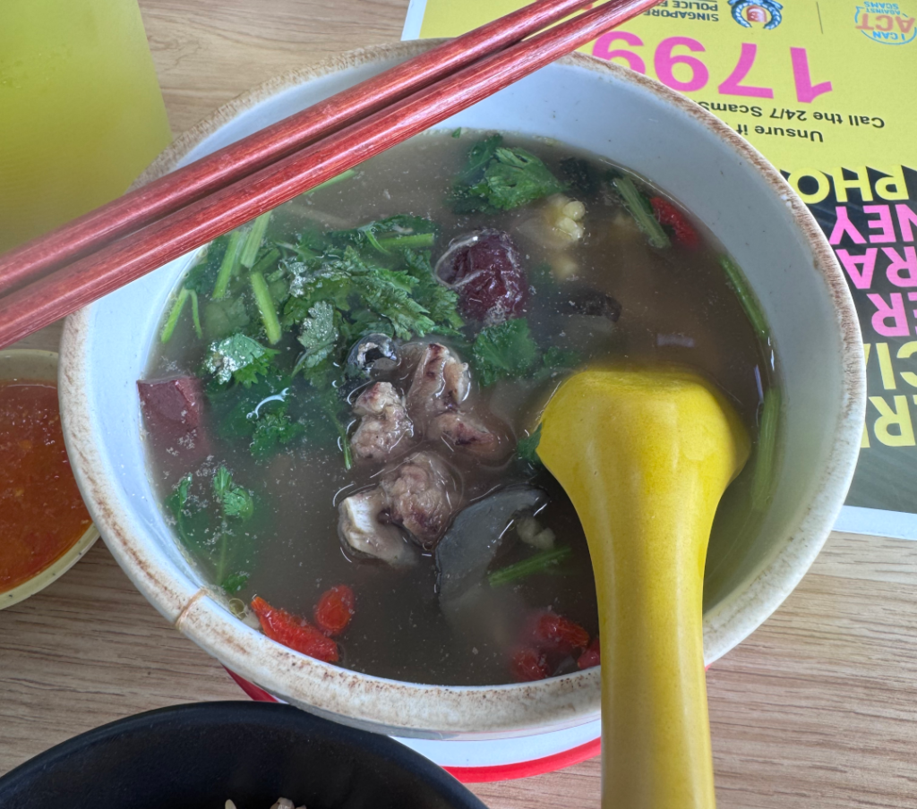 Bowl of Fu He stewed turtle soup with red dates, wolfberries and coriander, with yam rice and chilli on the side