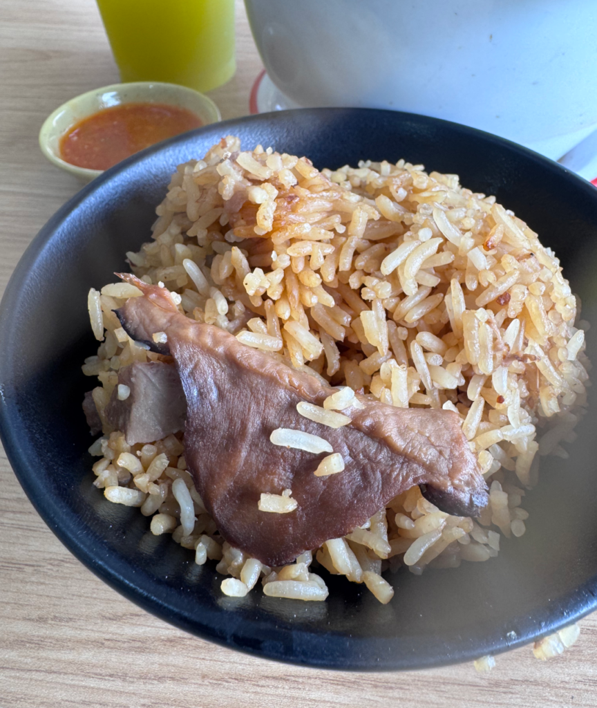 Bowl of yam rice with mushroom and bits of yam, served with turtle soup