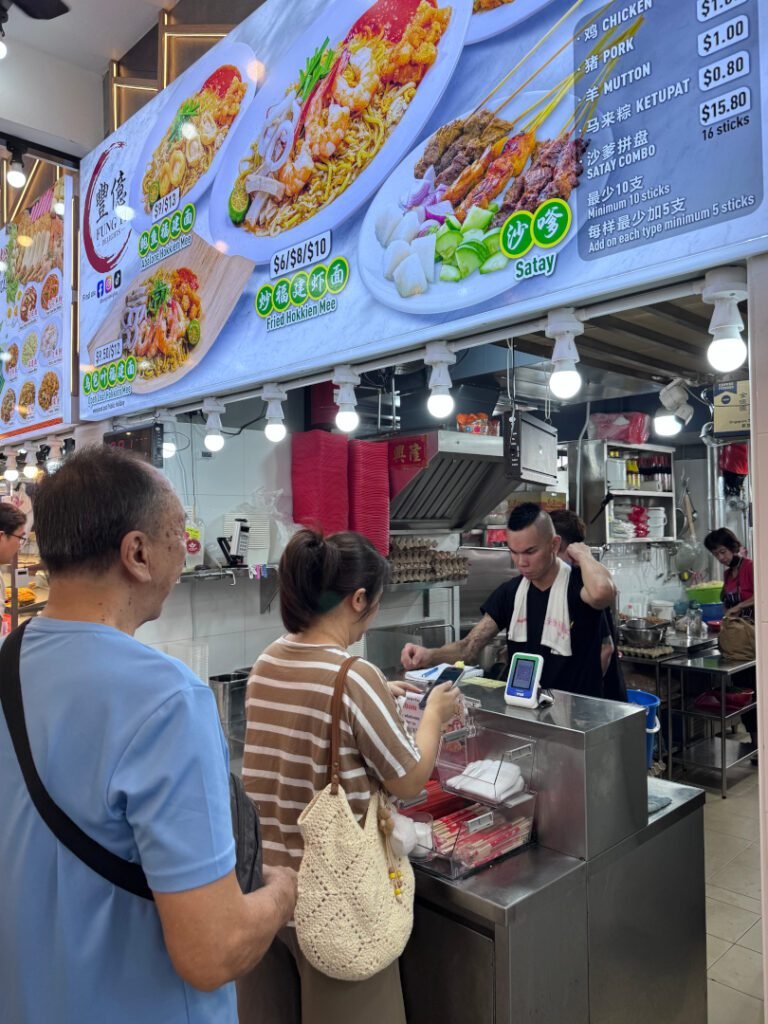 Fung Yi Hokkien Mee stall counter with signboard showing Fried Hokkien Mee at $6, $8 and $10