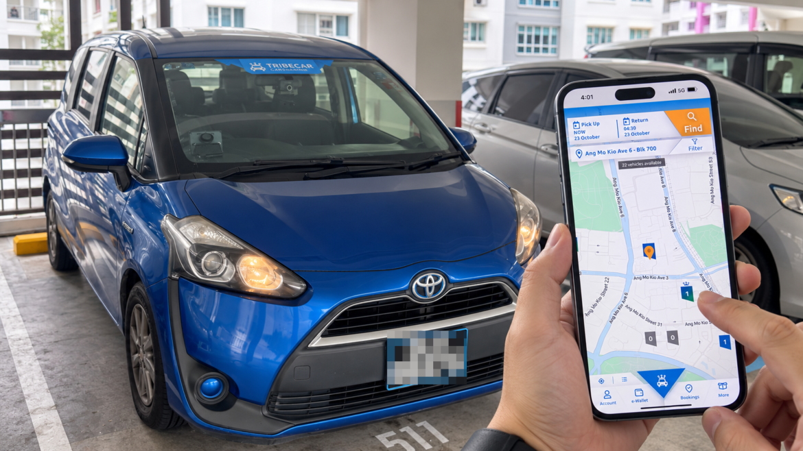Tribecar review Singapore: blue Toyota Sienta Hybrid in an HDB carpark next to the Tribecar app on a phone