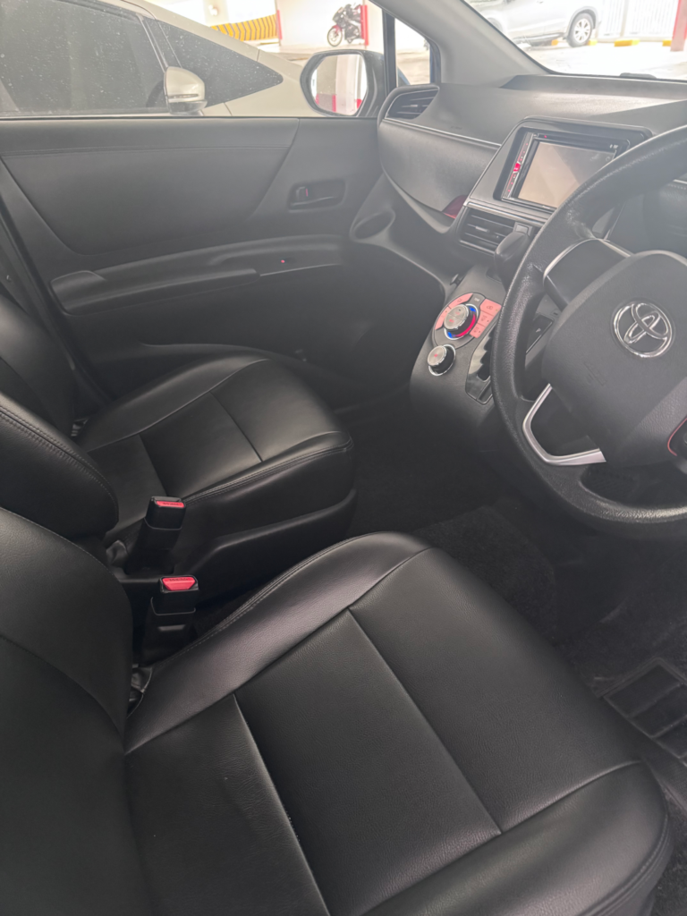 Clean black leather front seats in a Tribecar Toyota Sienta Hybrid